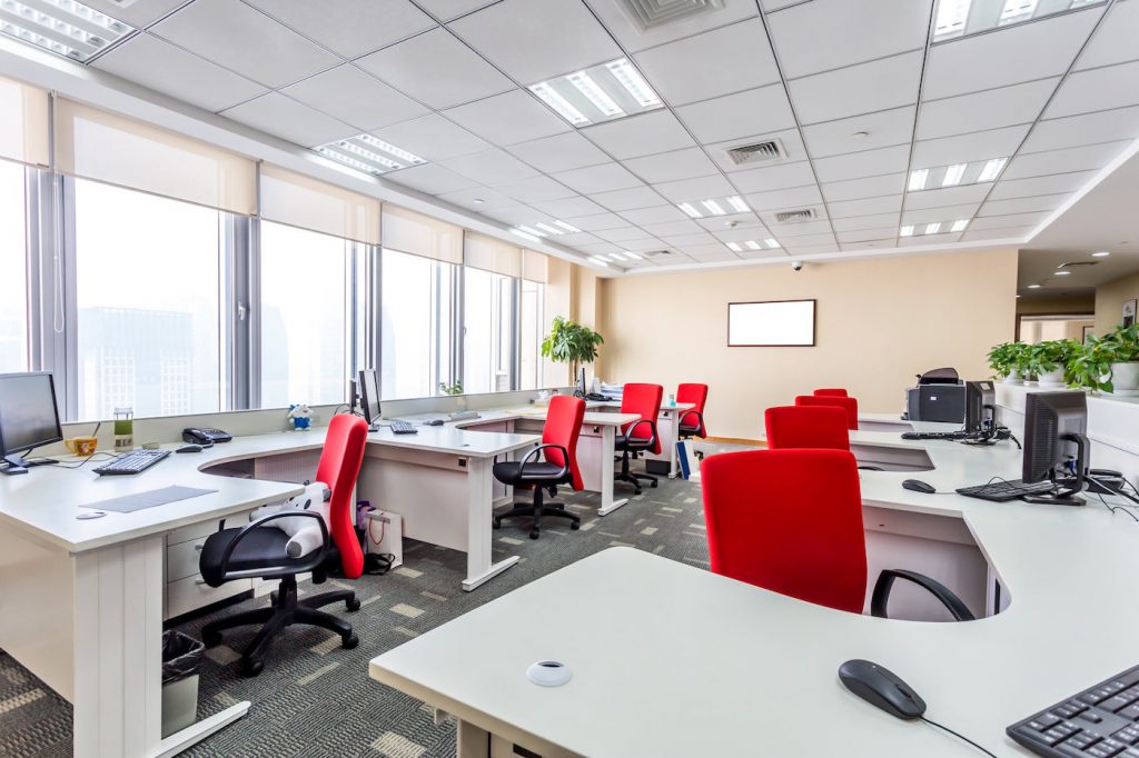 Open-plan commercial office with desks and shared work areas
